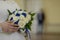 a girl in a wedding dress holds the bride\'s wedding bouquet