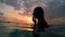 girl with wet hair and lips in the sunset in the water underwater