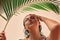 Girl with wet hair under palm tree