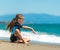 Girl in a wetsuit on the beach