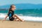 Girl in a wetsuit on the beach