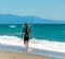 Girl in a wetsuit on the beach