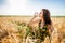 Girl in wheat field. Girl pours milk into a glass