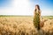 Girl in wheat field. Girl pours milk into a glass