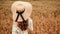 Girl wheat field summer. Happy young woman in sun hat in summer wheat field at sunset. Nature, summer holidays, vacation