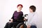 Girl in wheelchair talking with Helper