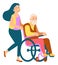 Girl wheeling old man in wheel chair. Smiling woman talking with senior