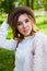 Girl in a white blouse and jeans posing on street in spring. Happiness and relax concept.