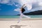 Girl with white cloth jumping on the beach