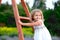 girl in a white dress climbs a wooden staircase in nature