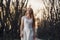 Girl in a white dress in the fairy forest. Mystery night