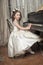 Girl in white dress at the piano