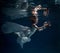 Girl in white dress posing under water with the boat