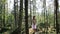 Girl in white dress standing in birch grove on sunny day