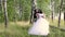 A girl in a white dress tenderly caresses the hand of a young man.