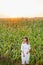 Girl in white dress . Woman in cornfield, place for text. Spike and girl in field. Late summer and early autumn. August