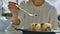 Girl in White Eats Chocolate Ice Cream with Spoon Closeup