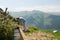 Girl in white pants and a blue blouse washes at a mountain spring