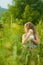 Girl with white pedigreed cat in her arms in a blue sundress