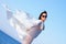 Girl in white sarong standing on the beach