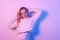 Girl in a white sweater in neon light. Masked woman, fashion photo