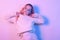 Girl in a white sweater in neon light. Masked woman, fashion photo