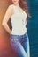 Girl in white tank shirt and blue jeans outdoor summer day lean on tiled wall