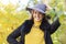 Girl white toothed smile, young happy woman whitened teeth in grey hat in autumn in the park. closeup portrait of stylish smiling