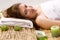 Girl in a white towel lying on spa treatments
