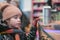 The girl at the window with sweets. Confectionery shop in winter