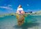 Girl windsurfer on a board in tropical clear water