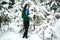 Girl in the winter forest. portrait of a girl. Girl in the winter walks in the woods. snow pours from branch