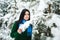 Girl in the winter forest. portrait of a girl. Girl in the winter walks in the woods. snow pours from branch