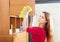 Girl wiping the dust from wooden furniture