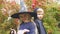 Girl in witch costume and boy-vampire posing for camera, Halloween celebration
