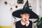 Girl in Witch costume eating soft jelly candy
