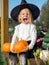 Girl in witch costume make scary faces