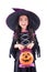 Girl witch with holding pumpkin bucket and smiles