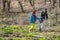 A girl and a woman collect garbage at the forest edge