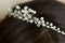 Girl or woman with dark hair with wedding hairstyle of barrette with rhinestones