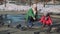 Girl and Woman Feeding Pigeons with Bread Crumbs