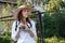 Girl woman hat sun vintage camera travel tourist photo camera shooting street white