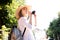 Girl woman hat sun vintage camera travel tourist photo camera shooting street white