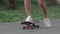 girl or woman skateboarding in the park in short denim shorts