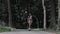 girl or woman skateboarding in the park in short denim shorts