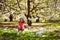 Girl in a wood with plastic bottles to create awareness