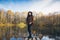 Girl on a wooden old bridge on a lake