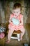 Girl on a wooden set with Easter dress