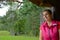 Girl in the woods sitting in the gazebo, looking at the sky, happy photo