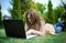 Girl work on laptop in garden